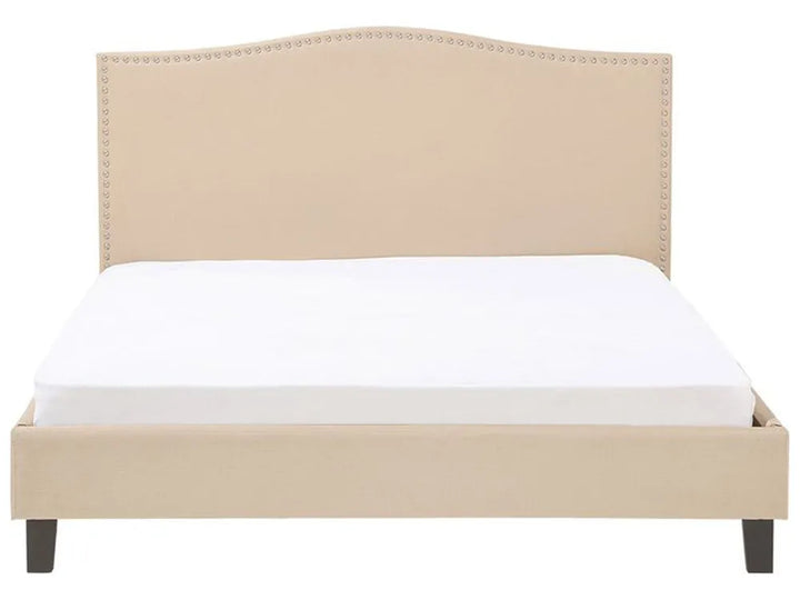 Beige upholstered bed with white mattress on a white background