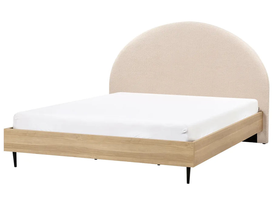 Bed with beige upholstered headboard and wooden frame on a white background