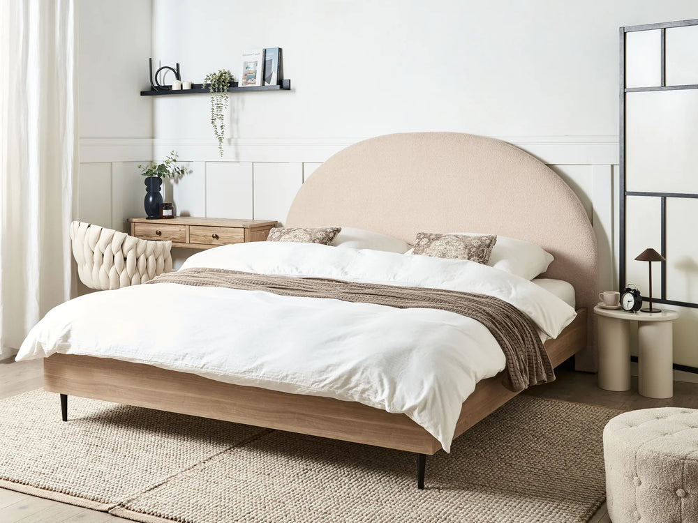 Beige upholstered bed with white bedding in a modern bedroom setting.