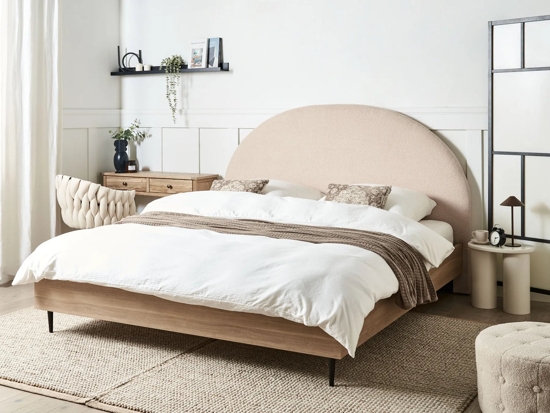 Beige upholstered bed with white bedding in a modern bedroom setting.