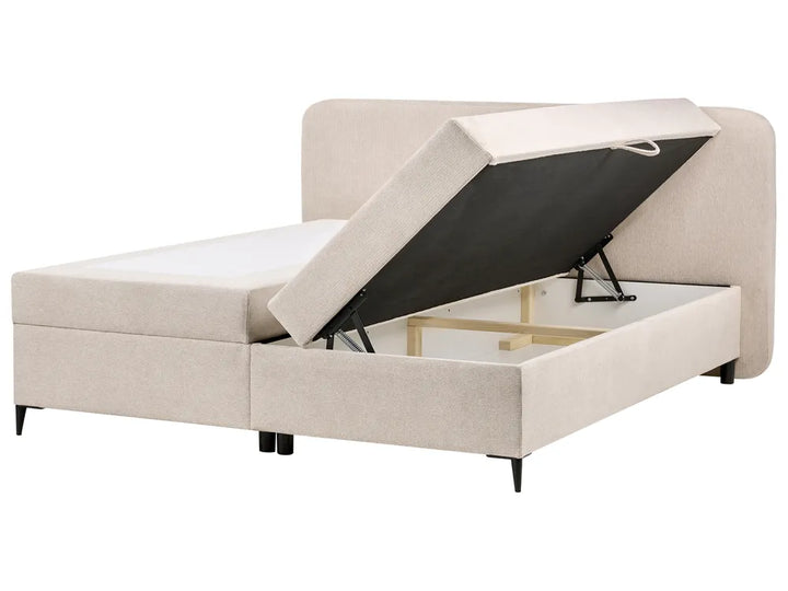 Beige upholstered bed with storage compartment on a white background
