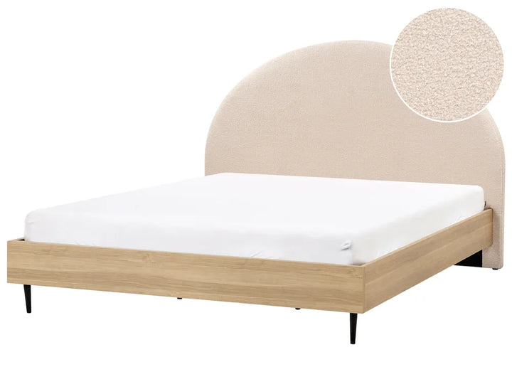 Beige upholstered bed frame with white mattress on a white background
