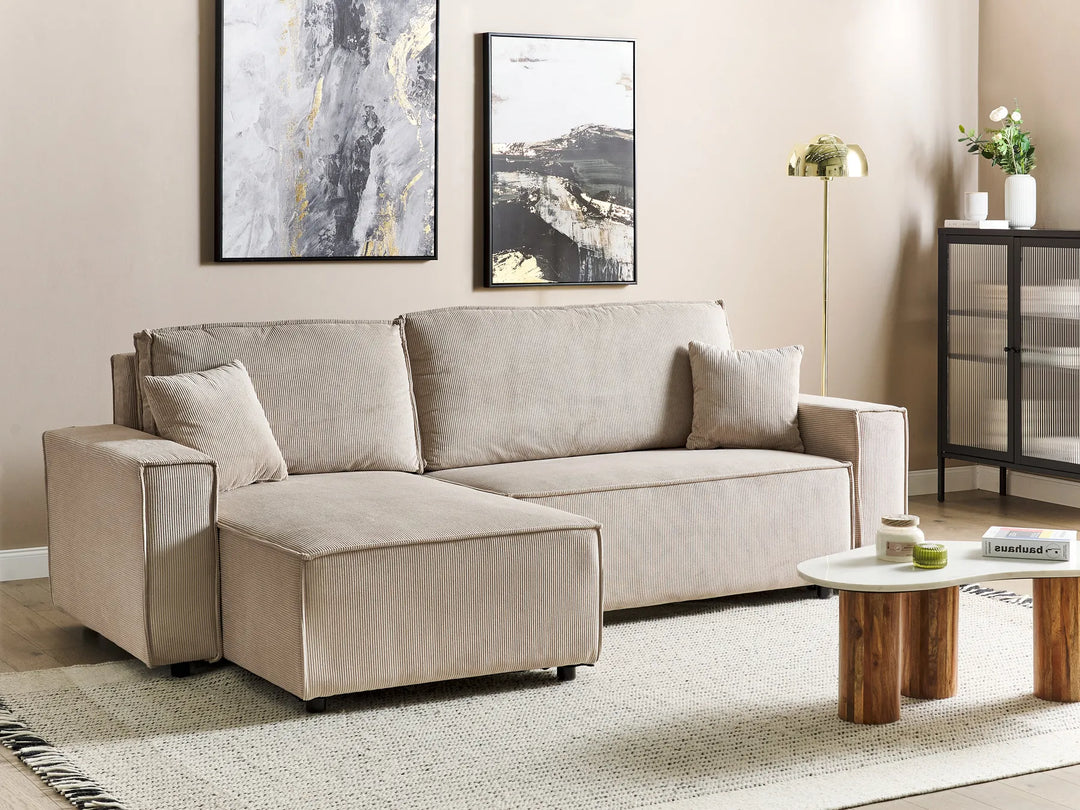 Beige sectional sofa in a living room with decor elements.