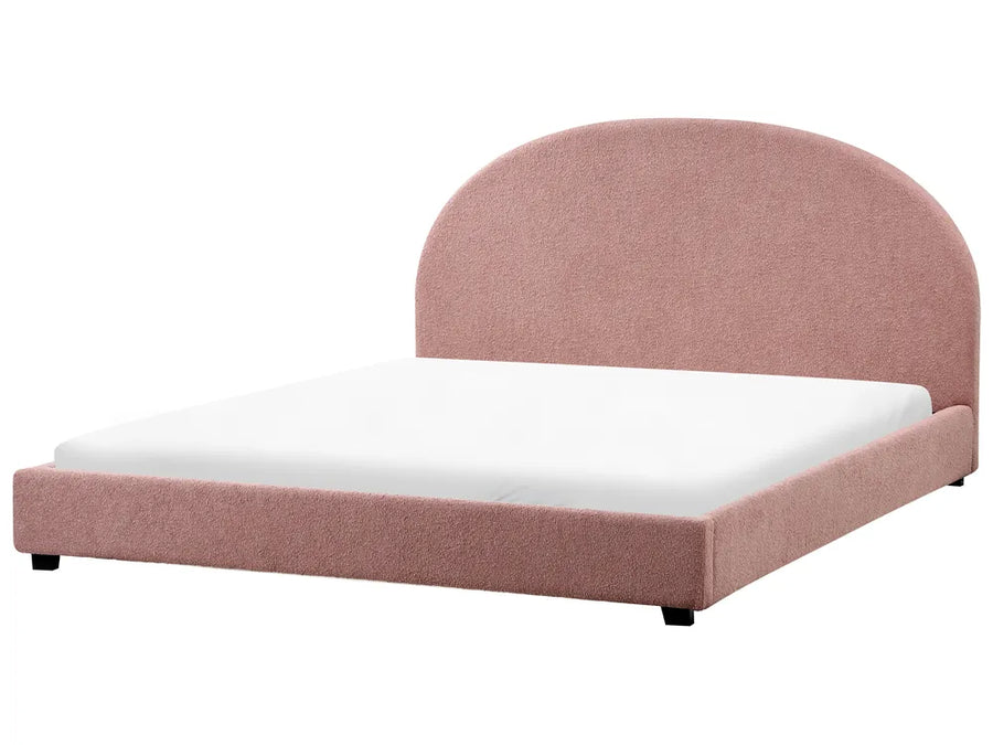 Pink upholstered bed with white mattress 