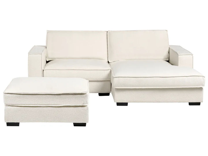 White sectional sofa with ottoman on a white background