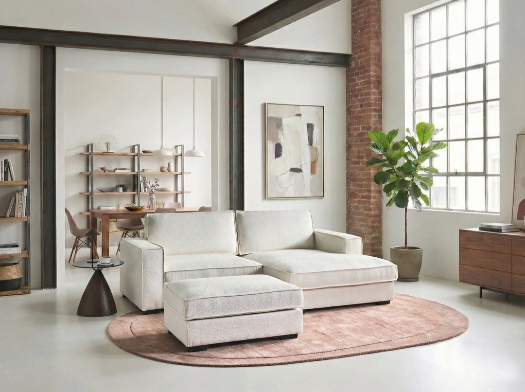 Modern living room with a white sofa, round rug, and large window.