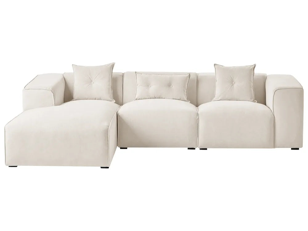 Beige sectional sofa with cushions on a white background