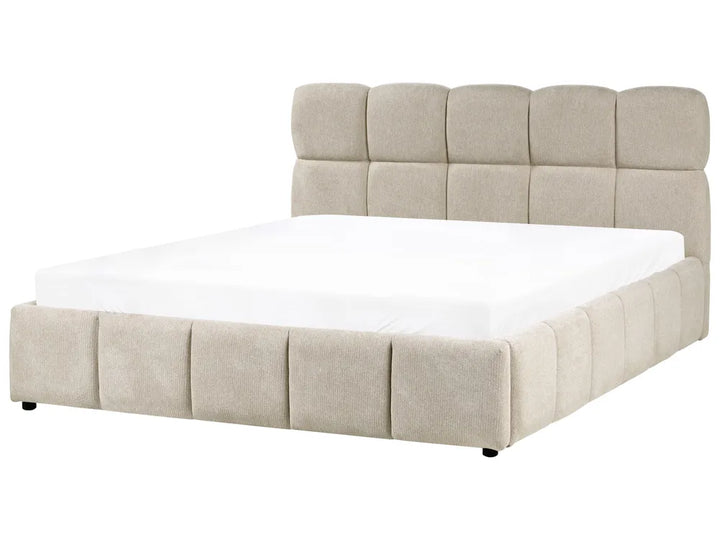 Beige upholstered bed with white mattress on a white background