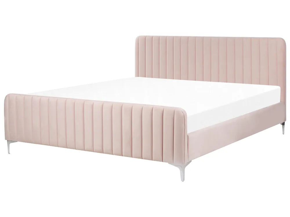 Pink upholstered bed with white mattress on a white background