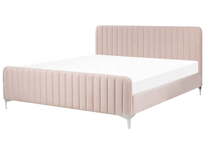 Pink upholstered bed with white mattress on a white background