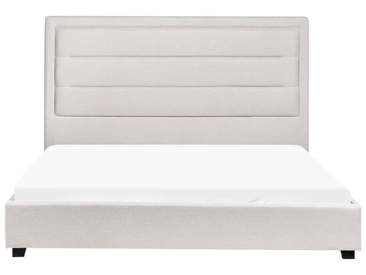 White upholstered bed with a matching headboard on a white background