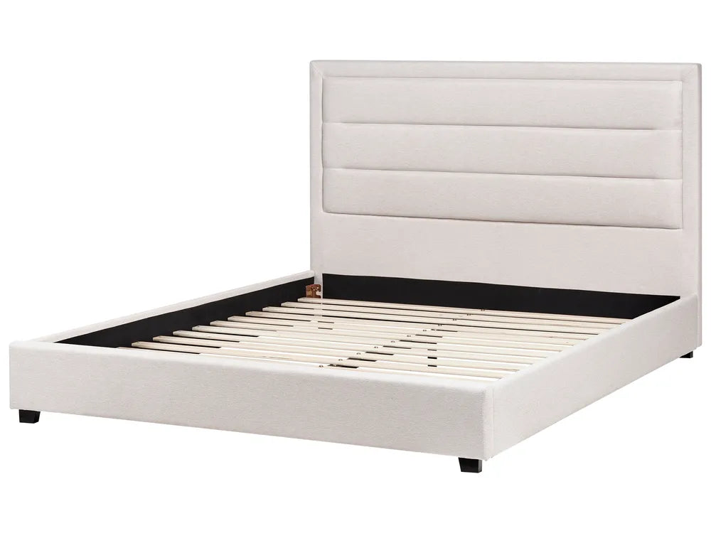 White upholstered bed frame on a white background