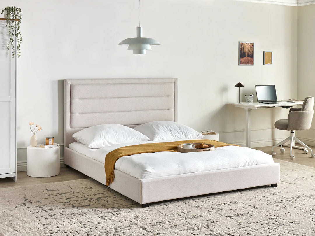 Modern bedroom with a bed, desk, and chair.