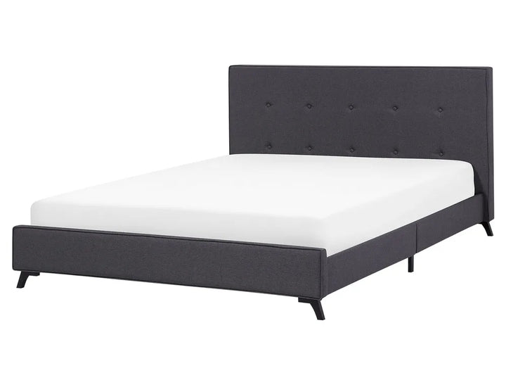 Black upholstered bed with white mattress on a white background