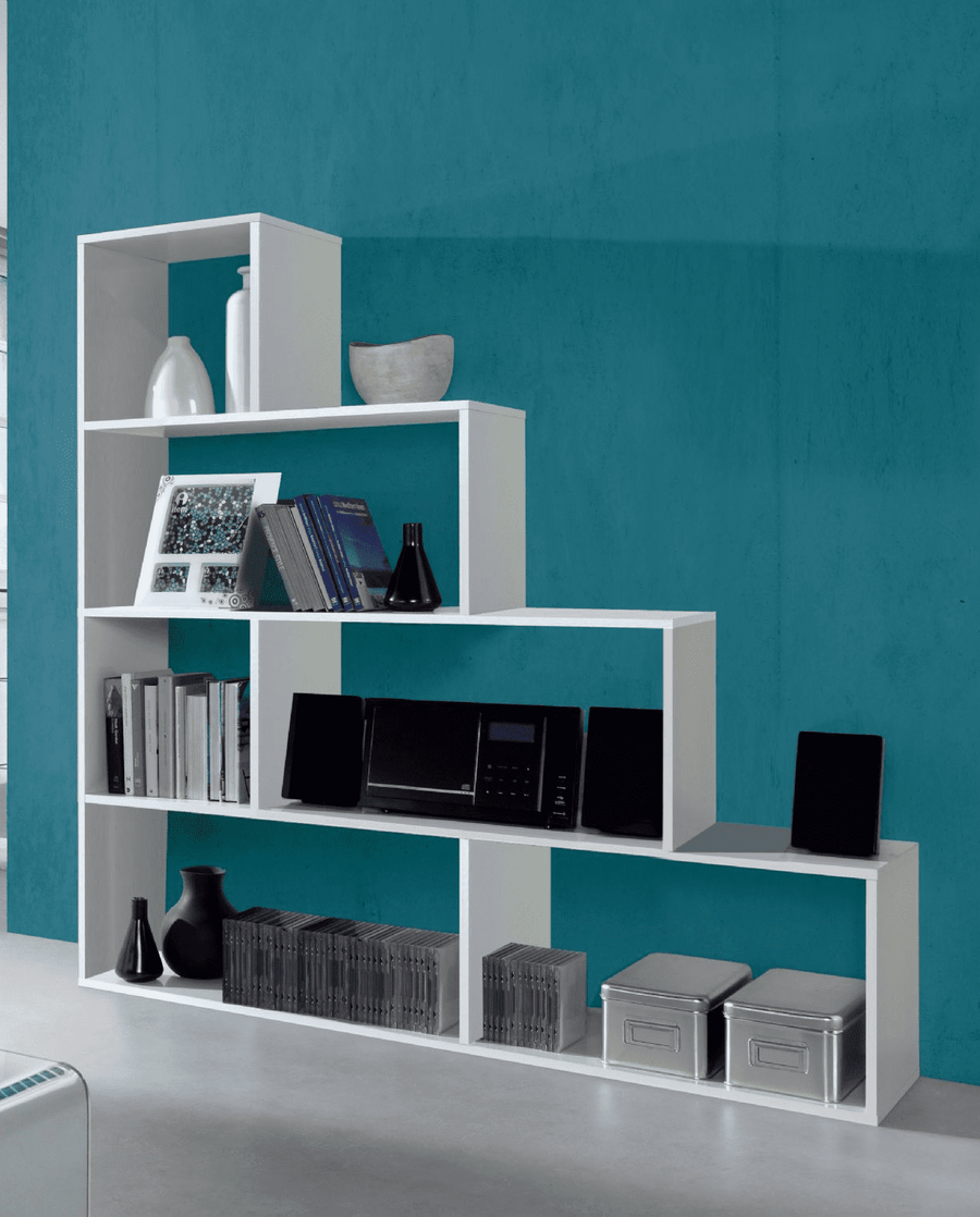 White bookshelf with various items against a blue wall