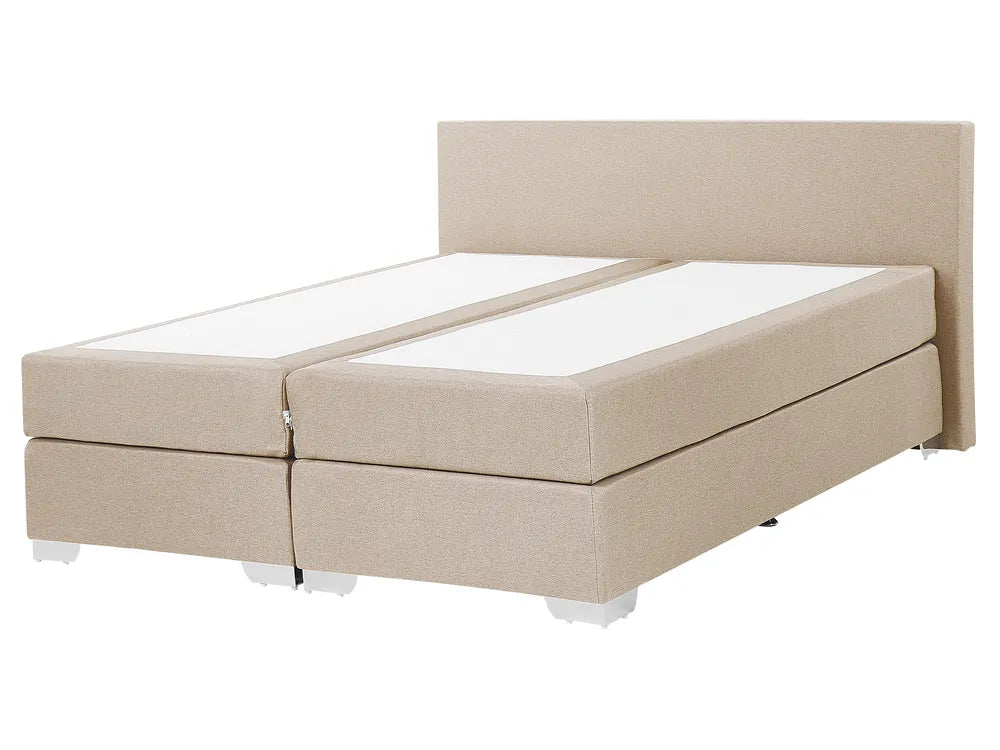 Beige boxspring bed with white mattress on a white background