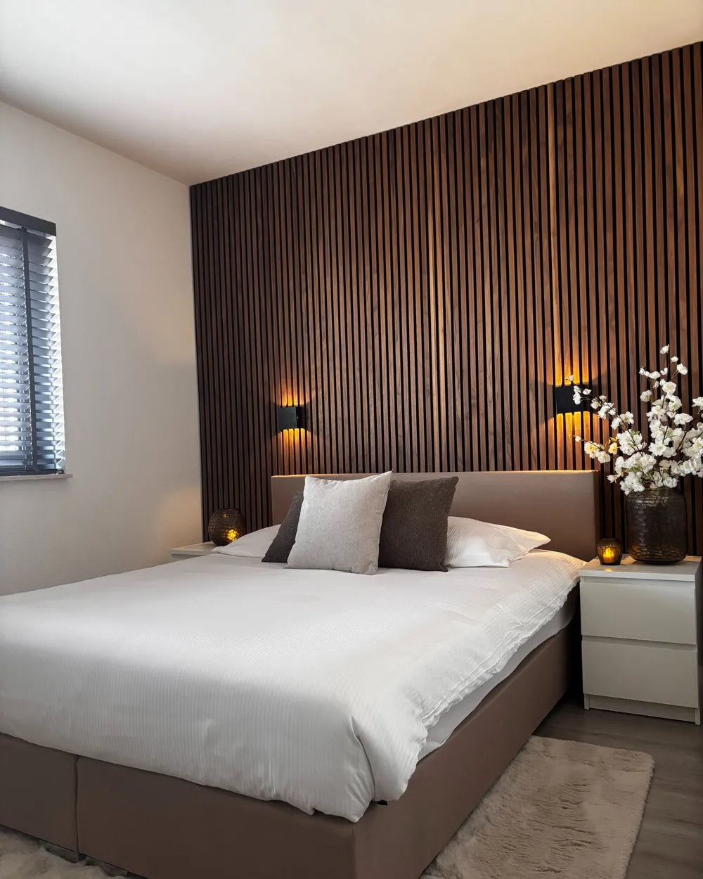 Modern bedroom with wooden headboard and decorative elements