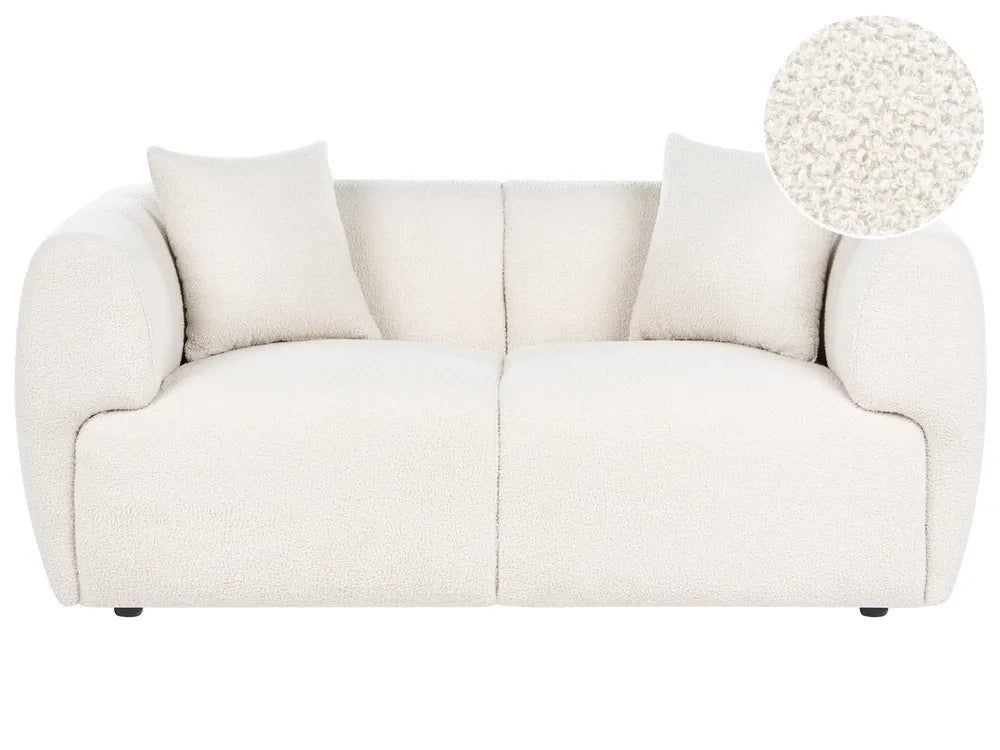 White sofa with a close-up of a cushion on a white background