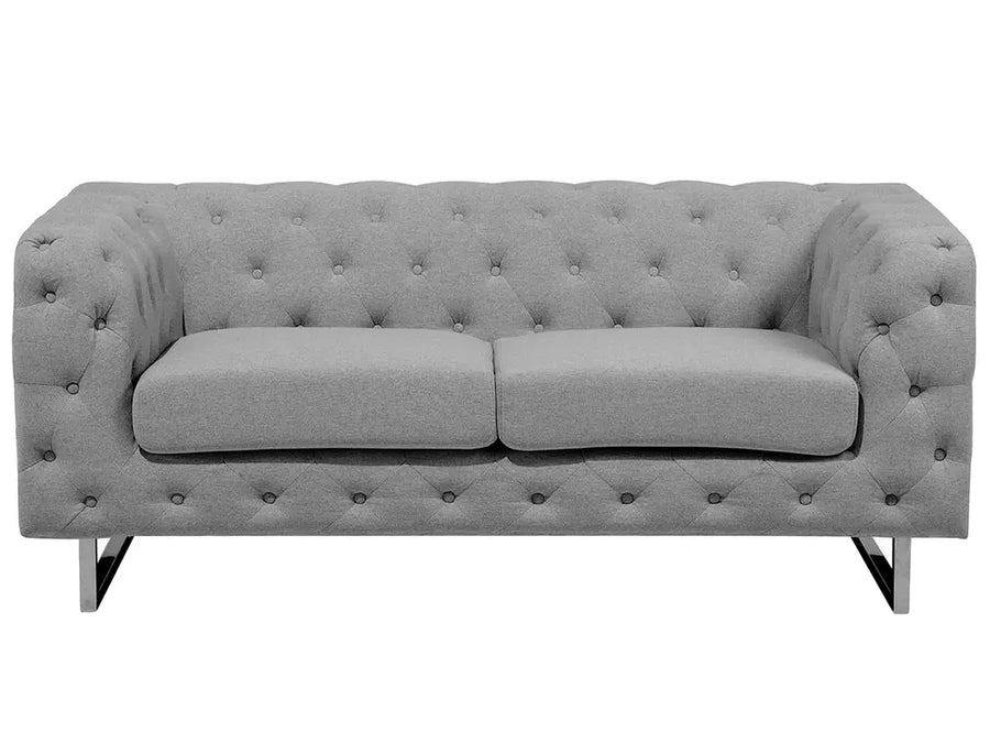 Gray tufted sofa on a white background