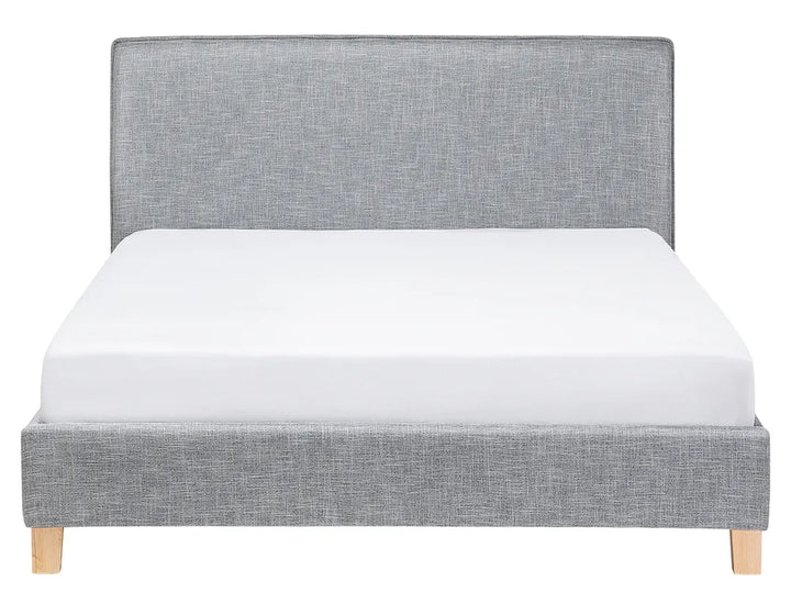 EU king bed with tall grey fabric headboard