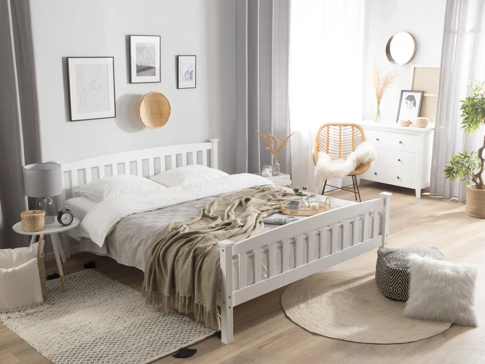 Neatly arranged bedroom with a white bed, wooden nightstands, and decorative elements.