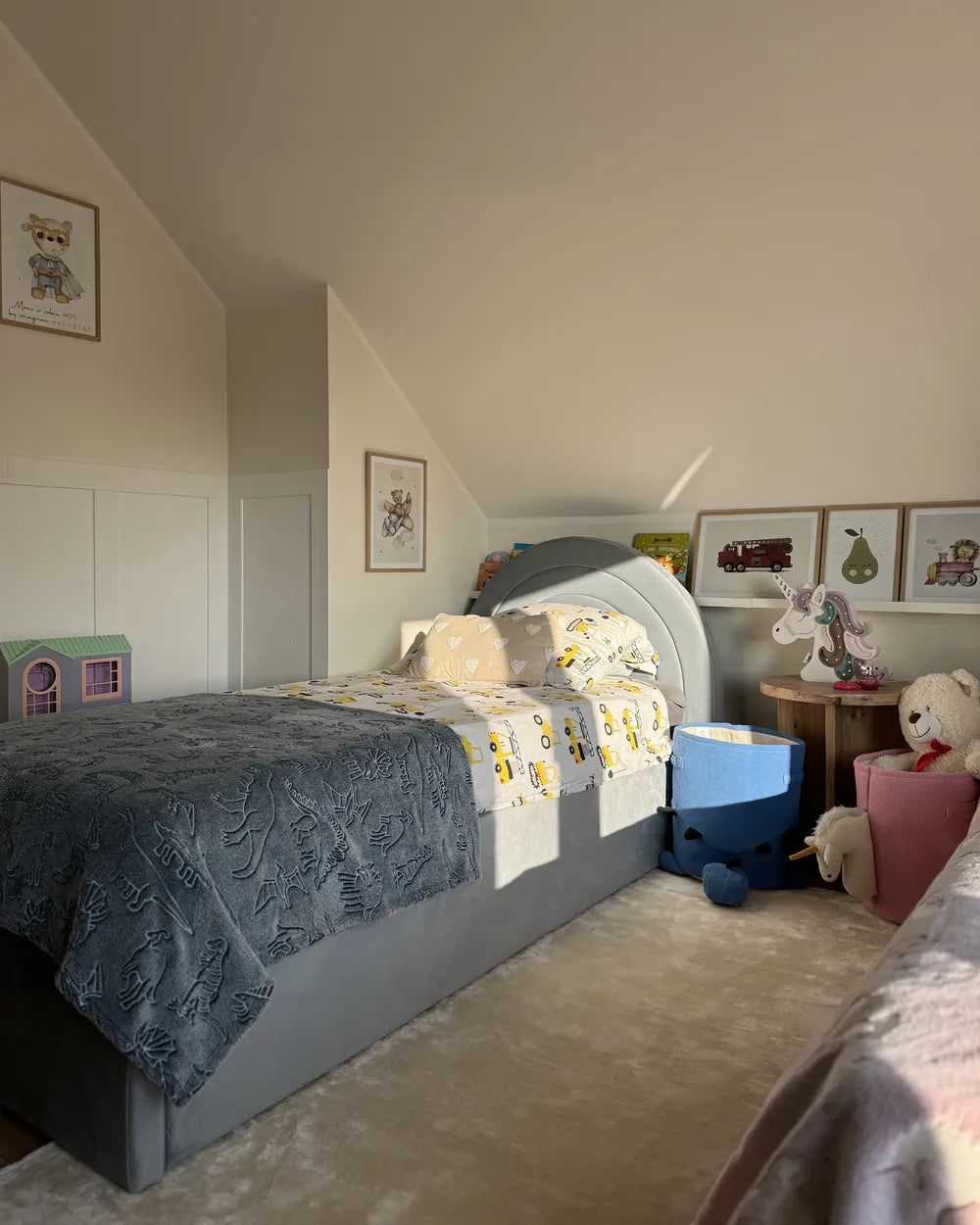 Children's bedroom with a bed, toys, and furniture.