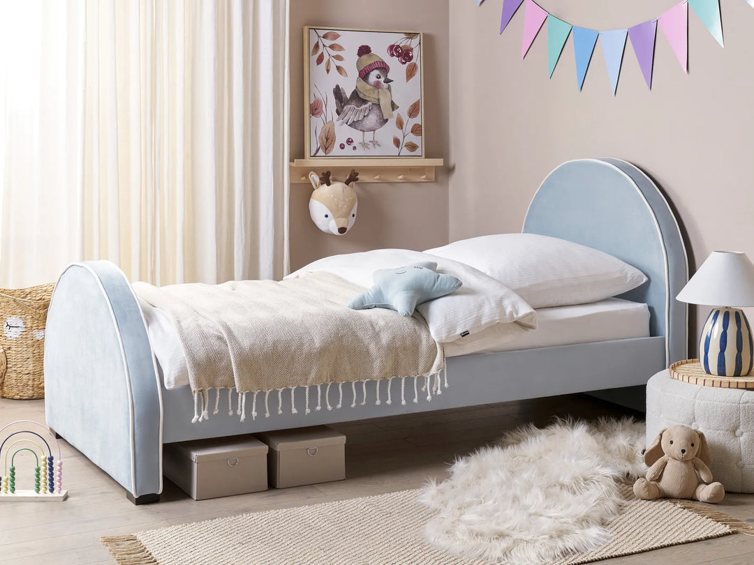 Children's bedroom with a gray bed, toys, and decorative elements.