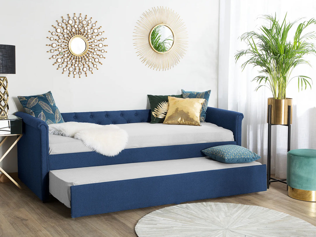 Blue sofa bed with white mattress in a stylish living room.