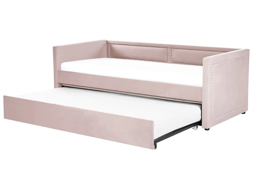 Pink upholstered bed with a white mattress on a white background