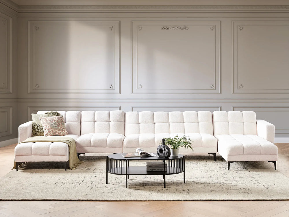 White sectional sofa in a living room with decorative elements.