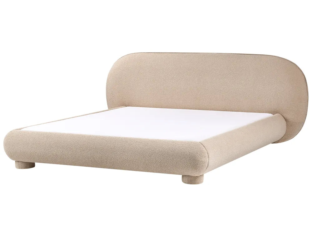 Beige upholstered bed with white mattress on a white background