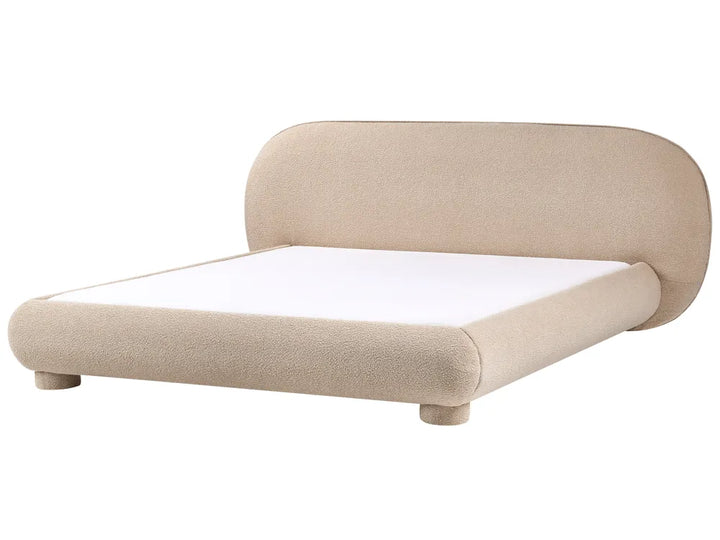 Beige upholstered bed with white mattress on a white background