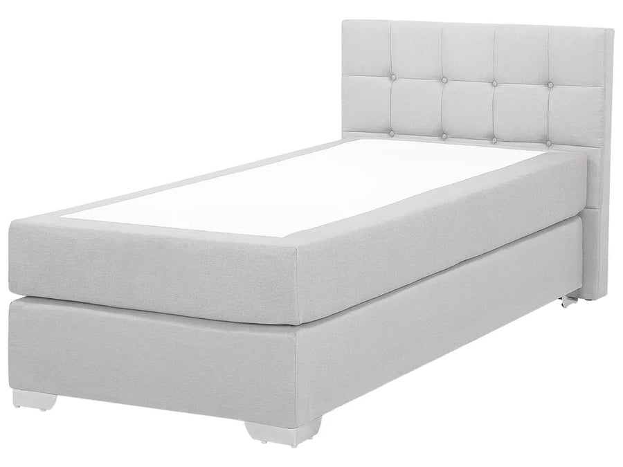 White upholstered bed with tufted headboard on a white background