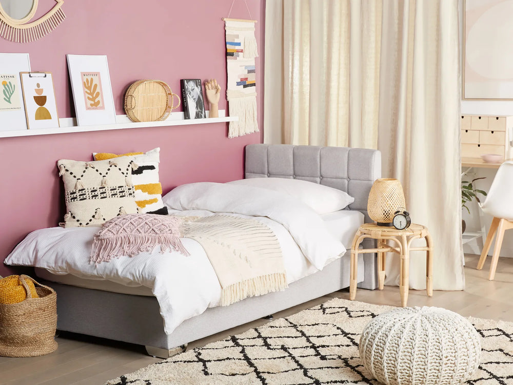 Neatly arranged bedroom with a bed, pillows, and decor items.