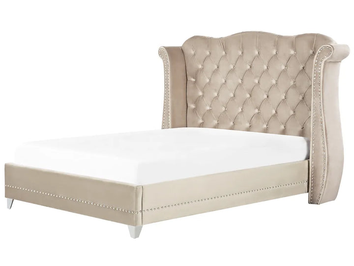 Beige upholstered bed with tufted headboard on a white background