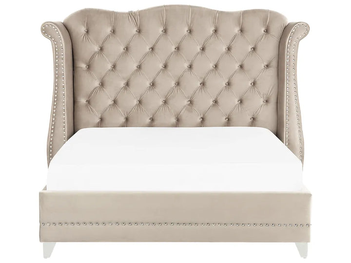 Beige tufted bed with white bedding on a white background