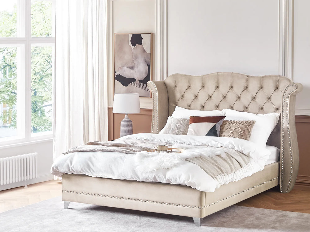Beige upholstered bed with tufted headboard in a bedroom setting.