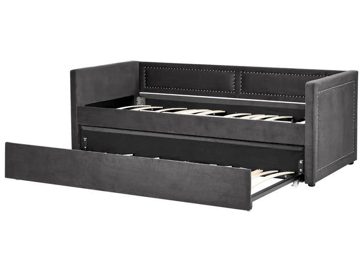 Black leather sofa bed with open drawer on a white background