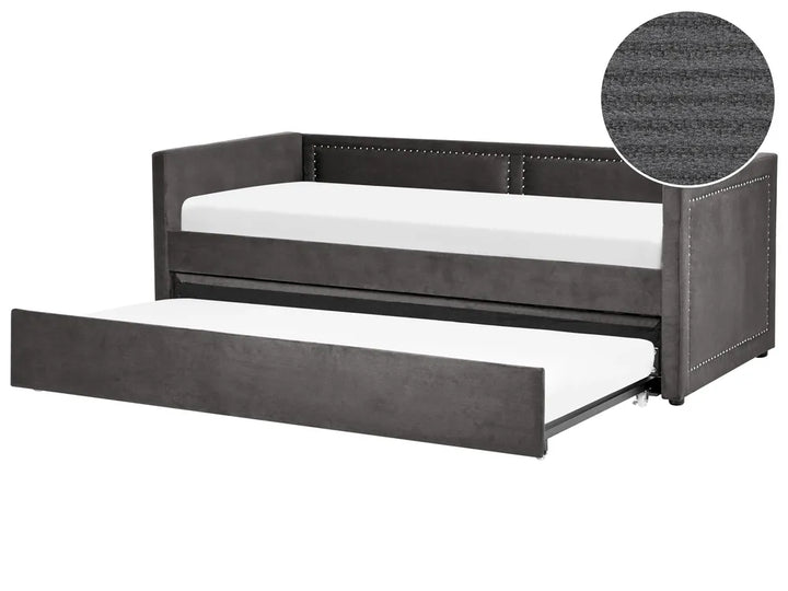 Gray upholstered bed with a white mattress on a white background
