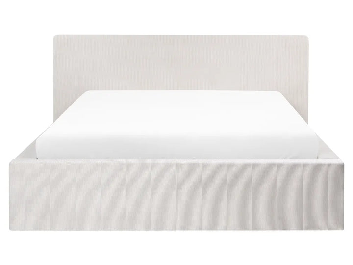 White bed frame with white mattress on a white background