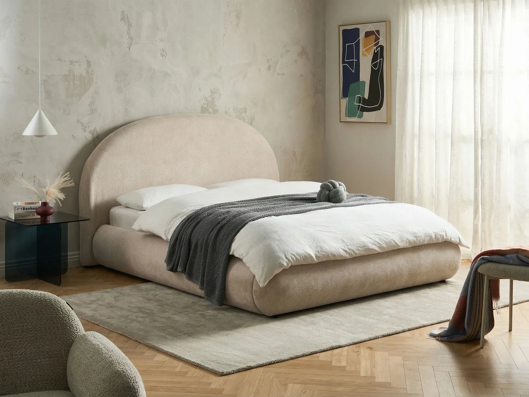 King size light beige ottoman bed with lift-up storage and rounded headboard