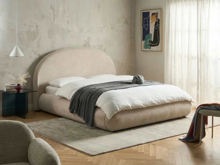 King size light beige ottoman bed with lift-up storage and rounded headboard