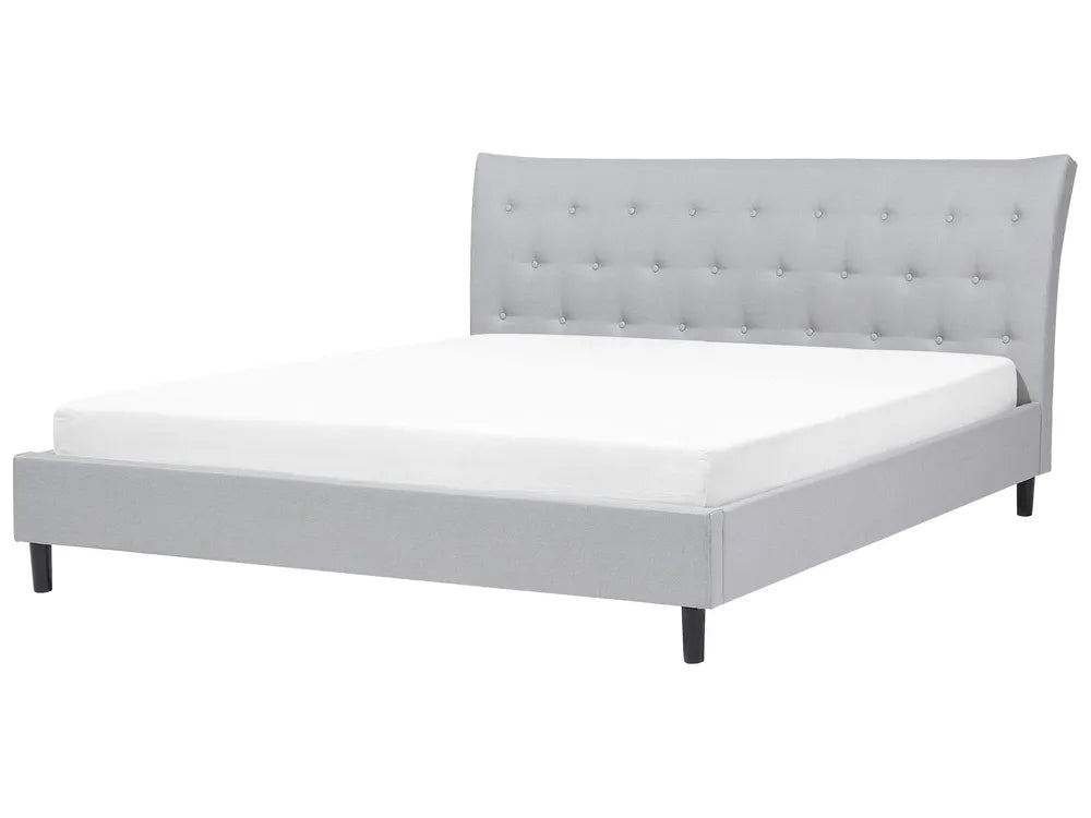 Gray upholstered bed with tufted headboard on a white background