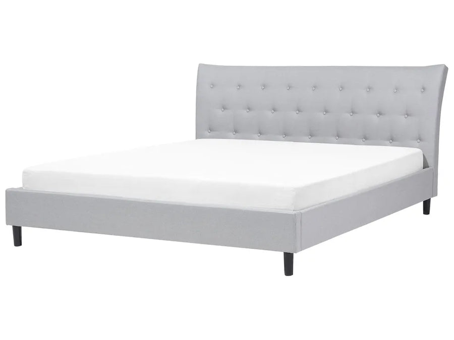 Gray upholstered bed with tufted headboard on a white background
