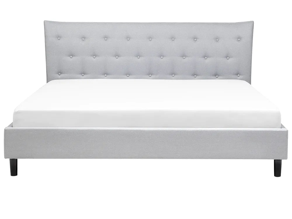 Gray upholstered bed with tufted headboard on a white background