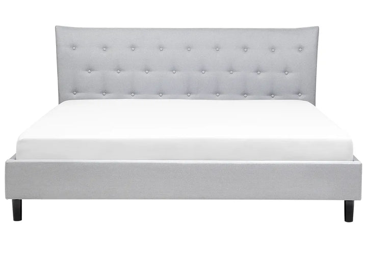 Gray upholstered bed with tufted headboard on a white background
