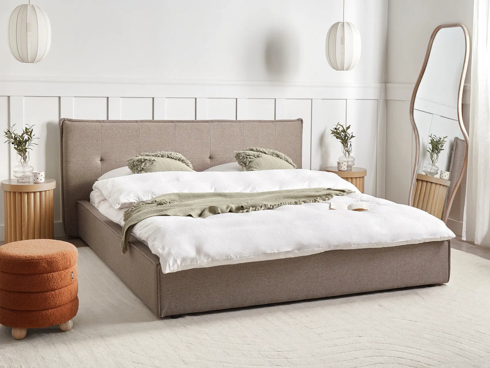Neatly made bed in a modern bedroom with neutral tones