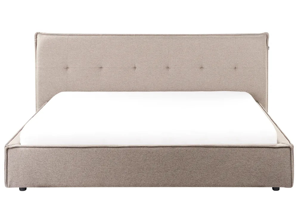 Beige upholstered bed with a white mattress on a white background