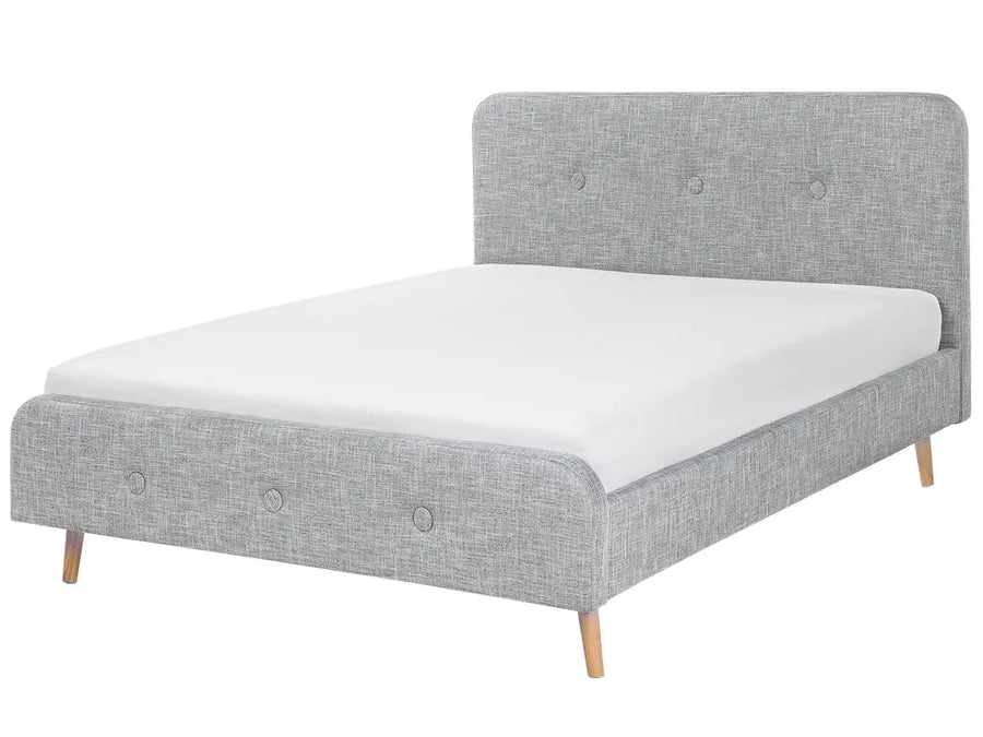 Gray upholstered bed with white mattress on a white background