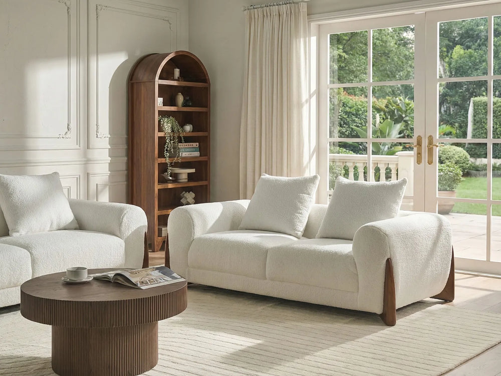 Living room with white sofa, armchair, and wooden coffee table.